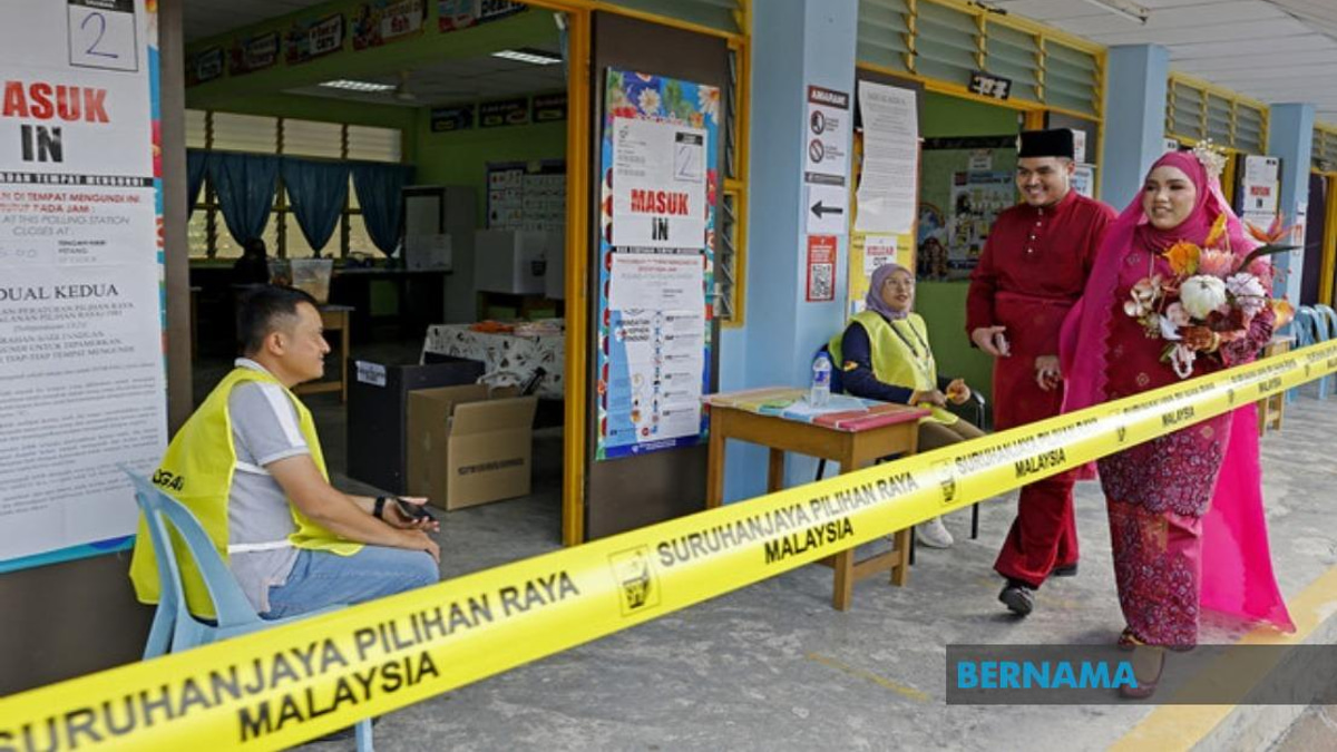 Young Bride Casts Vote in Traditional Wedding Gown at Negeri Sembilan Election