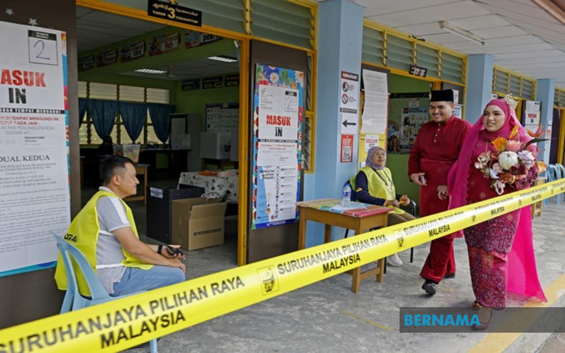 Young Bride Casts Vote in Traditional Wedding Gown at Negeri Sembilan Election